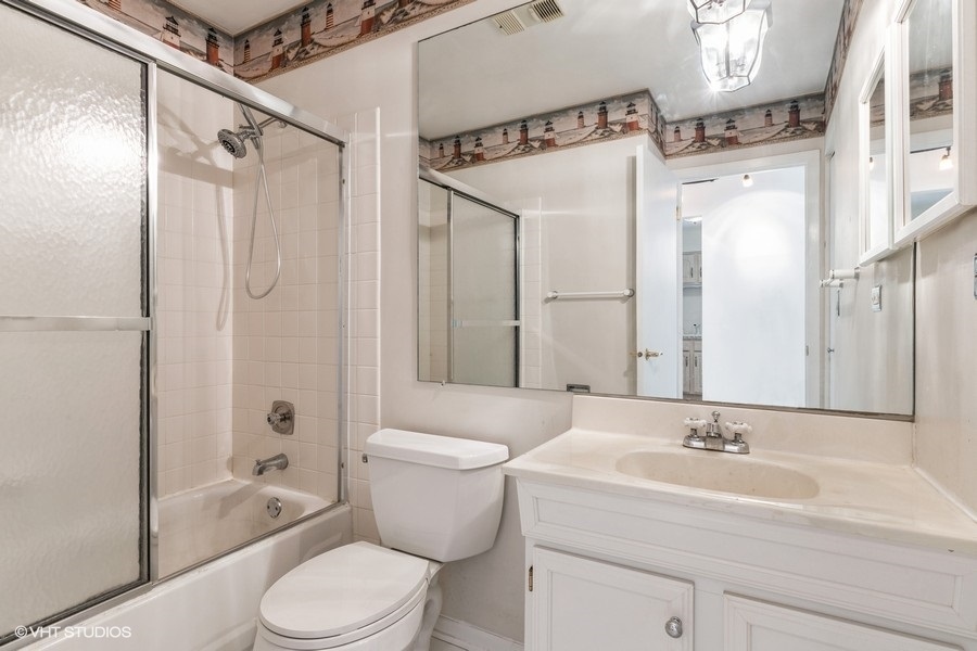1400 North Elmhurst Road, Unit 411 Mount Prospect, IL 60056 - Photo 10 of 13 a bathroom with a sink a toilet and shower