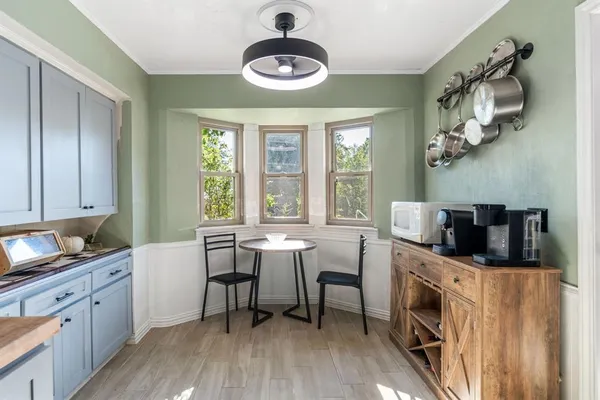 a kitchen with stainless steel appliances granite countertop a stove a sink dishwasher and a microwave with wooden floor