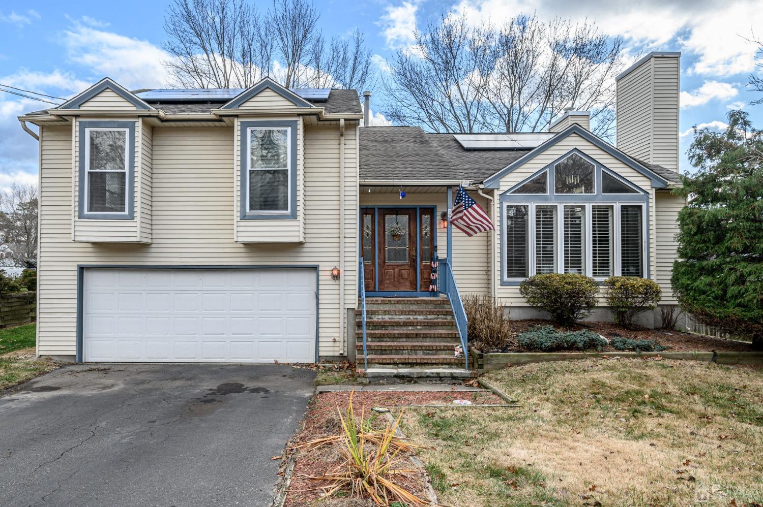 89 Friendship Road Howell, NJ 07731 - Photo 1 of 43 a front view of a house with a yard and garage
