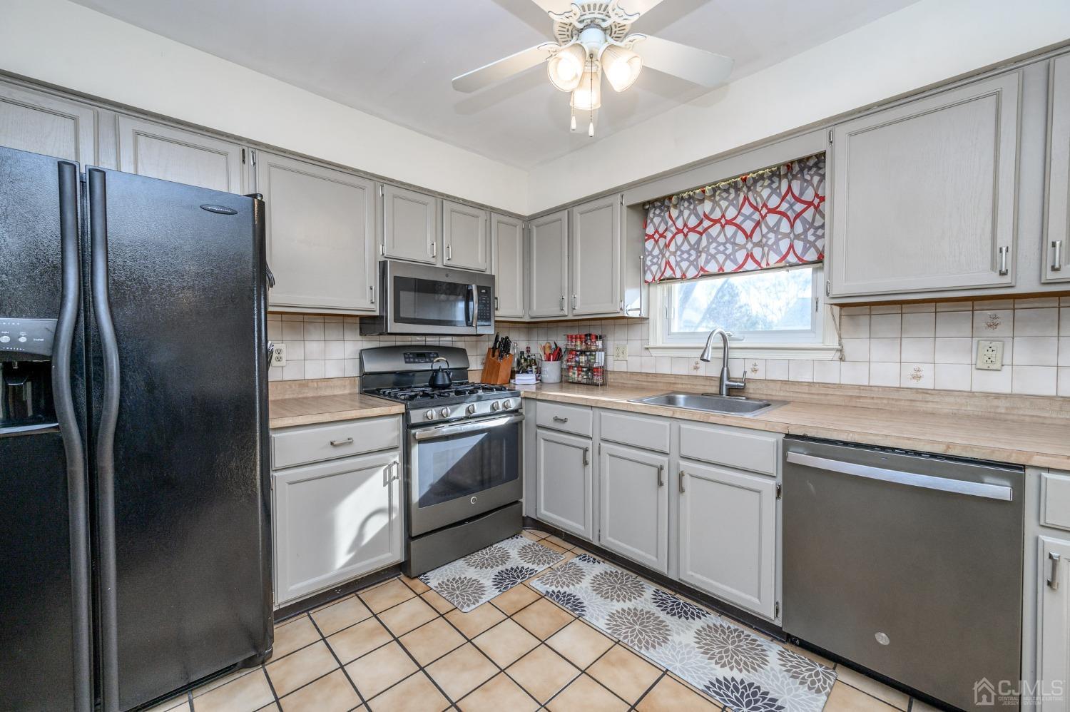 89 Friendship Road Howell, NJ 07731 - Photo 13 of 43 a kitchen with stainless steel appliances granite countertop a refrigerator sink and cabinets