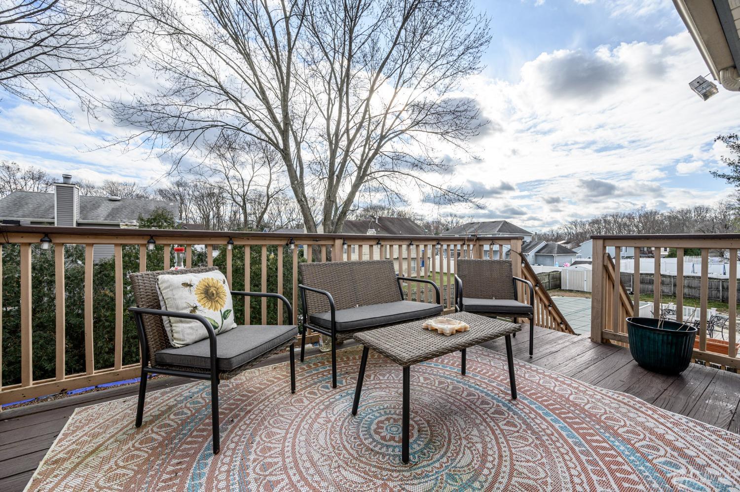 89 Friendship Road Howell, NJ 07731 - Photo 35 of 43 a roof deck with table and chairs and wooden floor