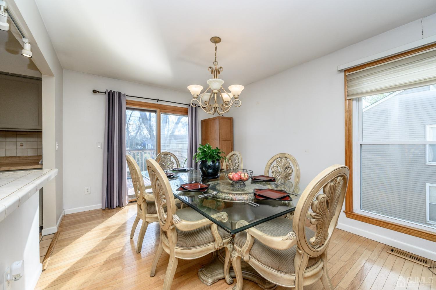 89 Friendship Road Howell, NJ 07731 - Photo 8 of 43 a dining room with furniture a chandelier and wooden floor