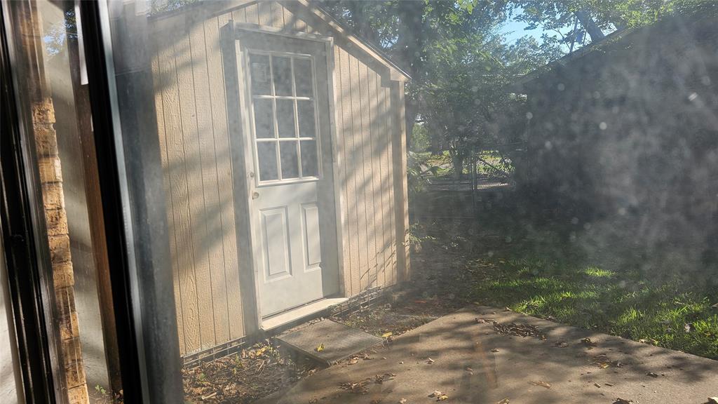606 Hunter Street Bonham, TX 75418 - Photo 7 of 9 a view of a glass door of a house