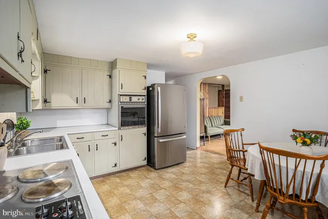 a kitchen with stainless steel appliances granite countertop a refrigerator and a stove top oven