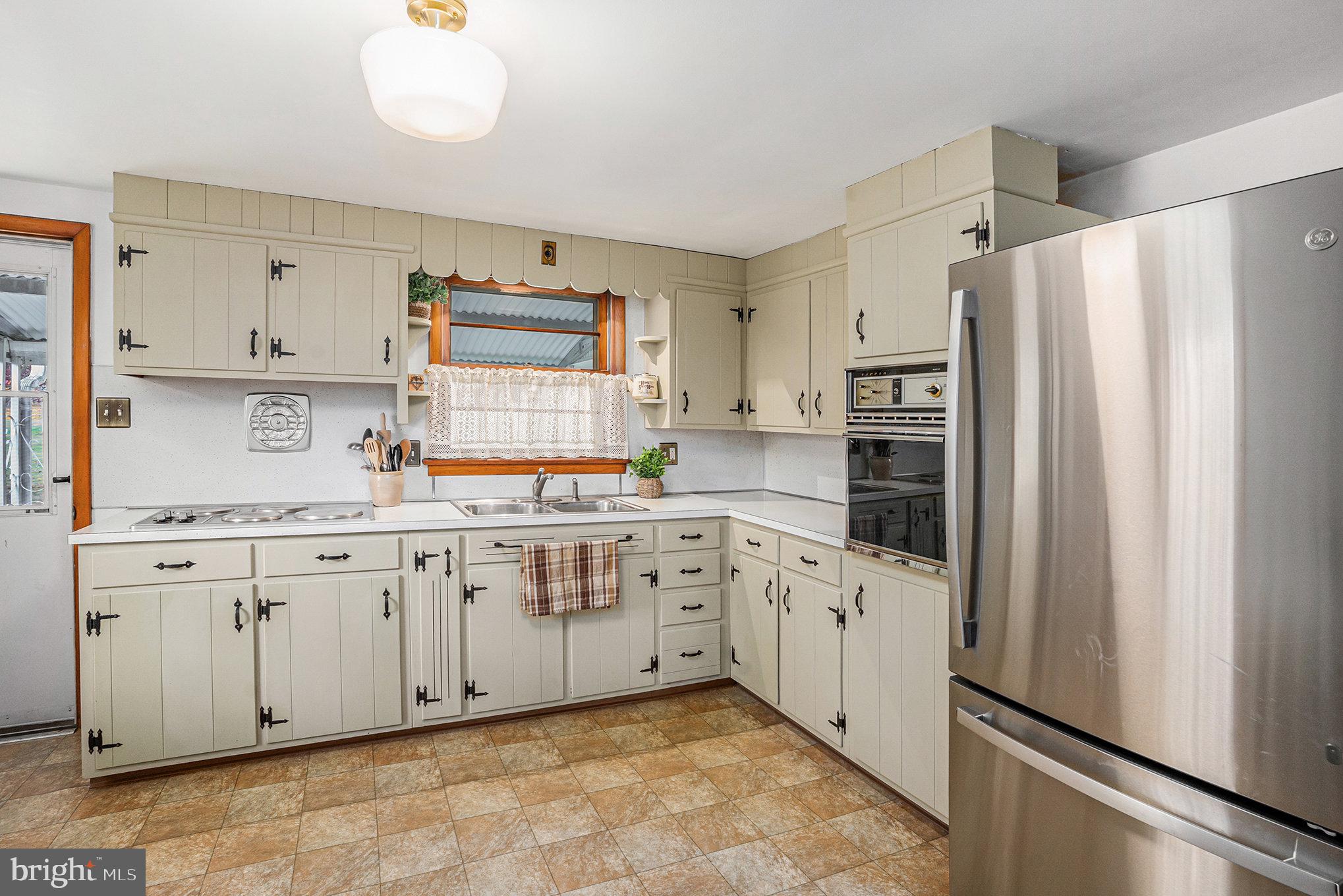 2390 Old Rte 100 Barto, PA 19504 - Photo 13 of 44 a kitchen with granite countertop white cabinets and refrigerator