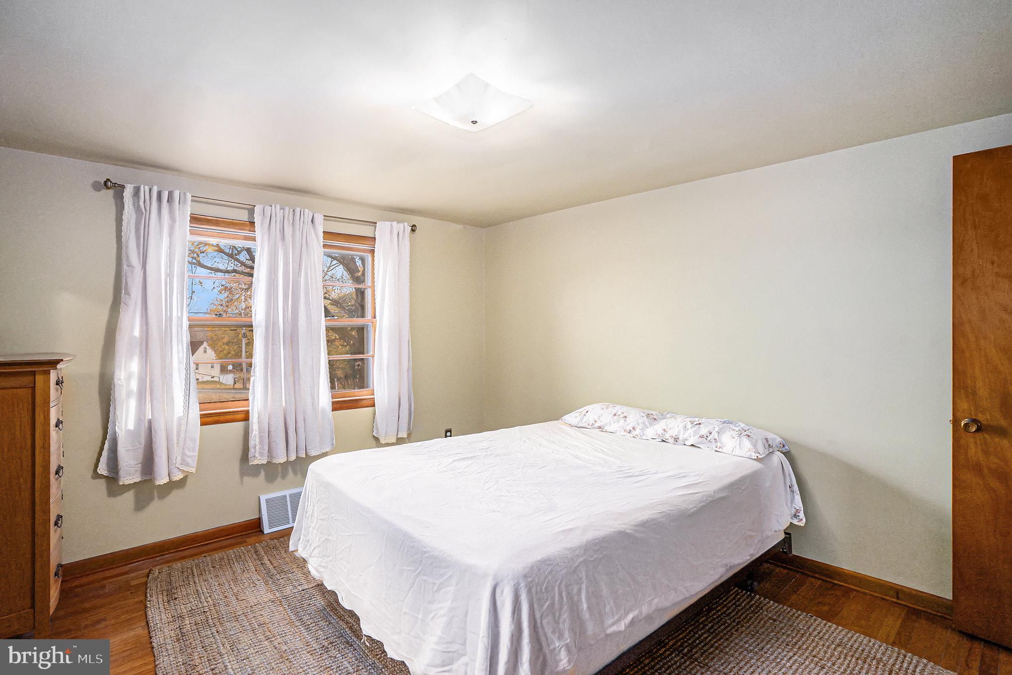 2390 Old Rte 100 Barto, PA 19504 - Photo 16 of 44 a bedroom with a bed and wooden floor