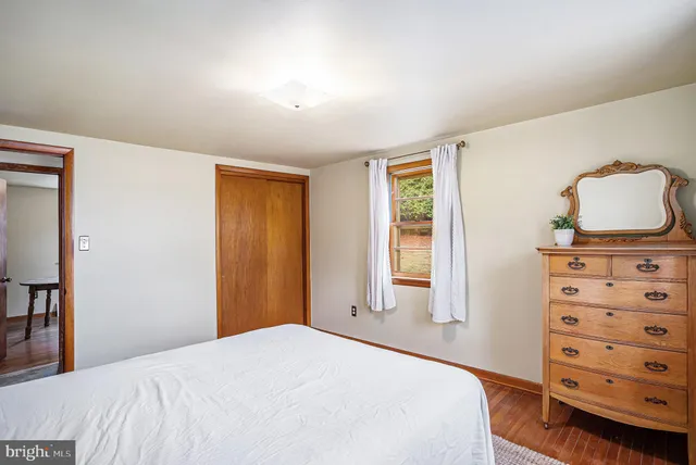 a bedroom with a bed and a dresser