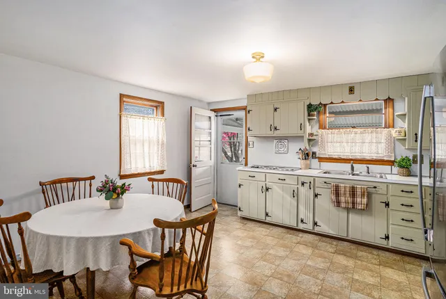 a kitchen with granite countertop a sink cabinets and window