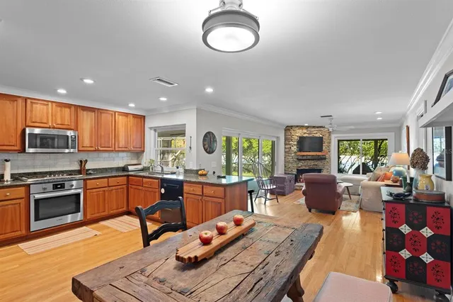 an aerial view of a house with a yard and lake view