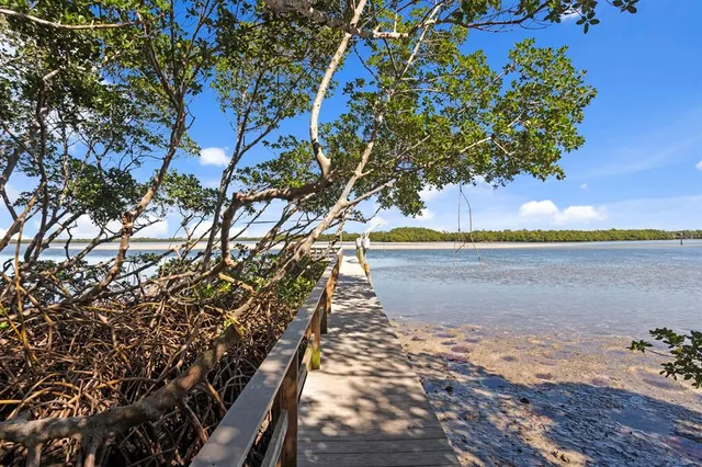 a living room with furniture a flat screen tv and a floor to ceiling window