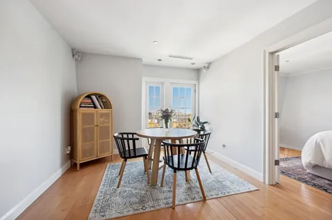 a view of a dining room with furniture and wooden floor