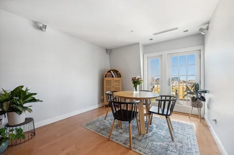 a view of a dining room with furniture and a potted plant