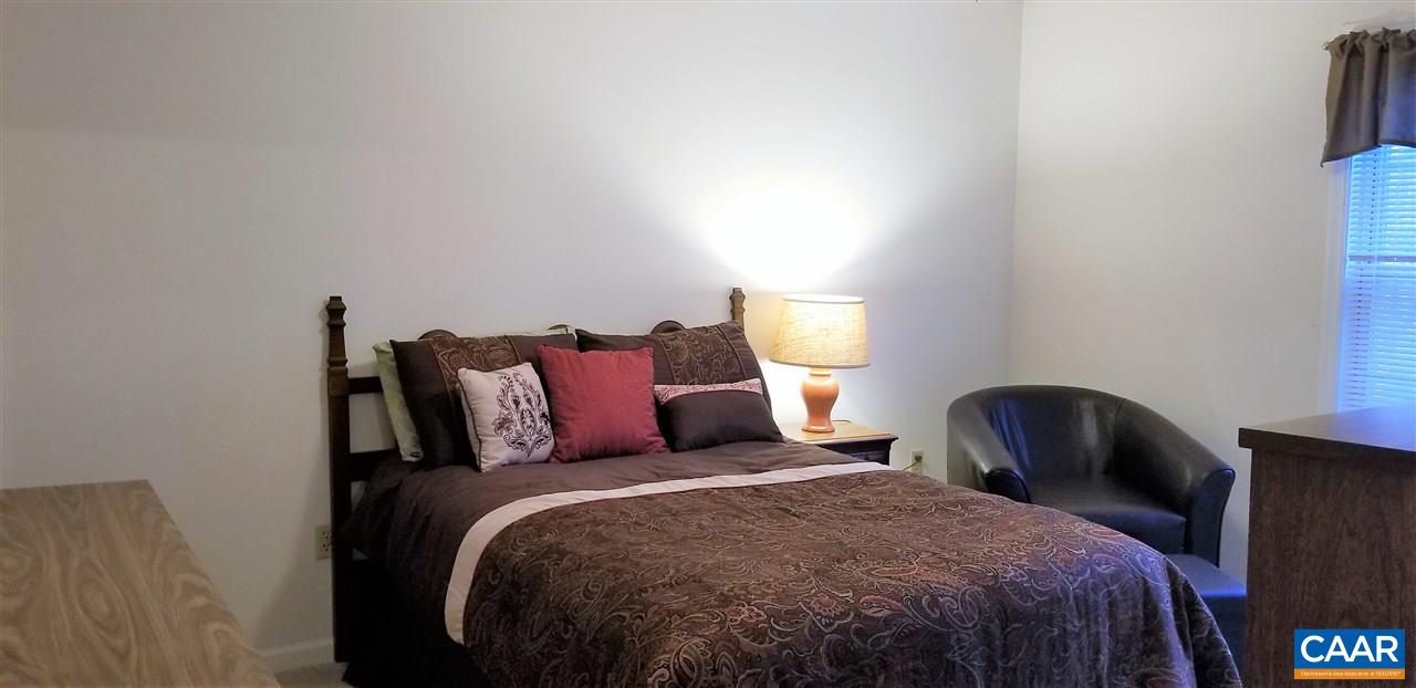13 Colonial Road Palmyra, VA 22963 - Photo 21 of 34 a bedroom with a bed and a chair with the outer view