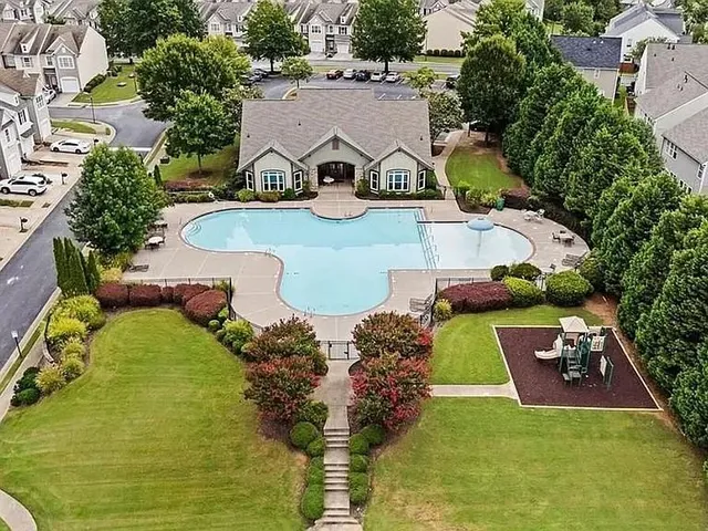 an aerial view of a house with yard swimming pool and outdoor seating