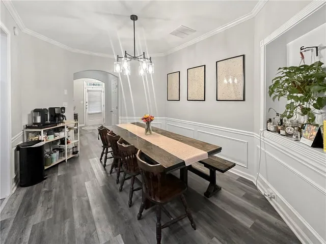 a kitchen with a table chairs refrigerator and microwave