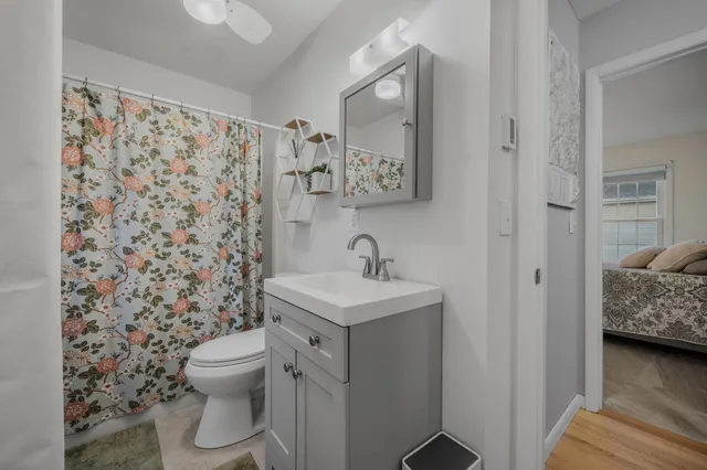 a bathroom with a sink toilet and a mirror