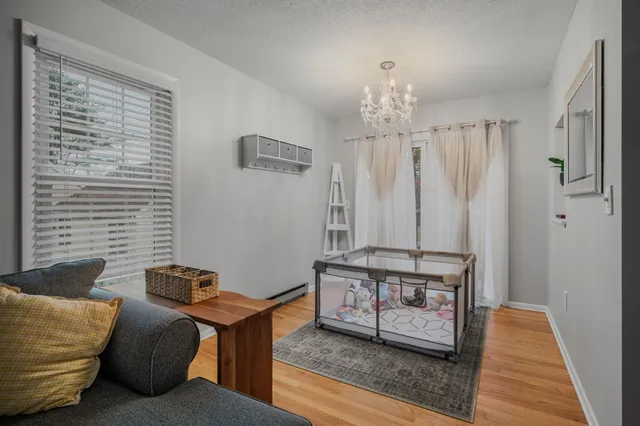 a living room with furniture and a chandelier