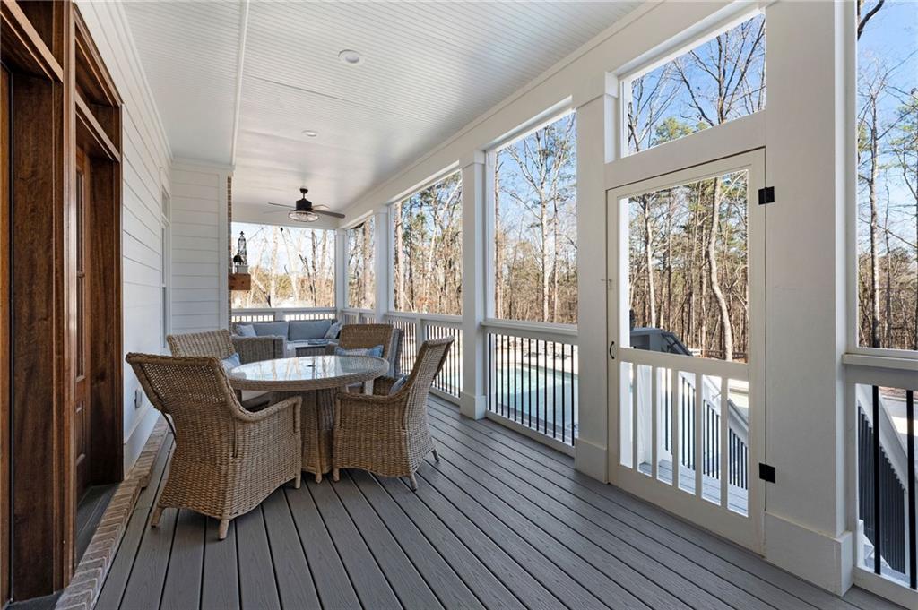 49 Cedar Gate Lane Kingston, GA 30145 - Photo 59 of 73 a dining room with wooden floor a glass table and chairs