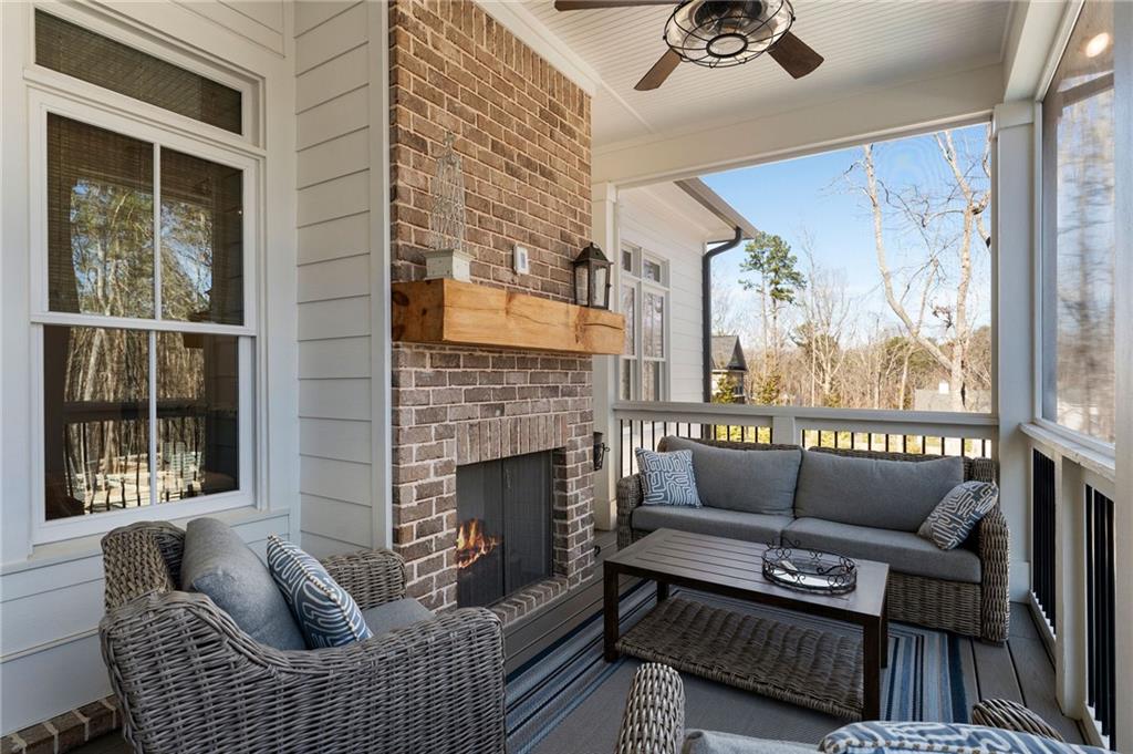49 Cedar Gate Lane Kingston, GA 30145 - Photo 60 of 73 a living room with furniture a fireplace and a floor to ceiling window