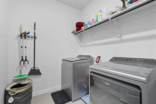 a view of walk in closet with clothes