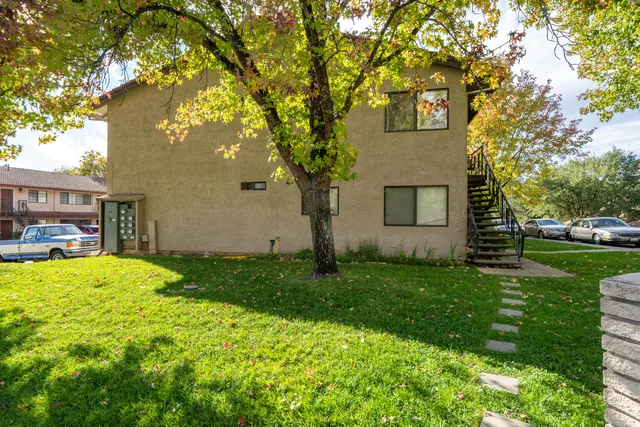 a house is sitting in middle od the grass