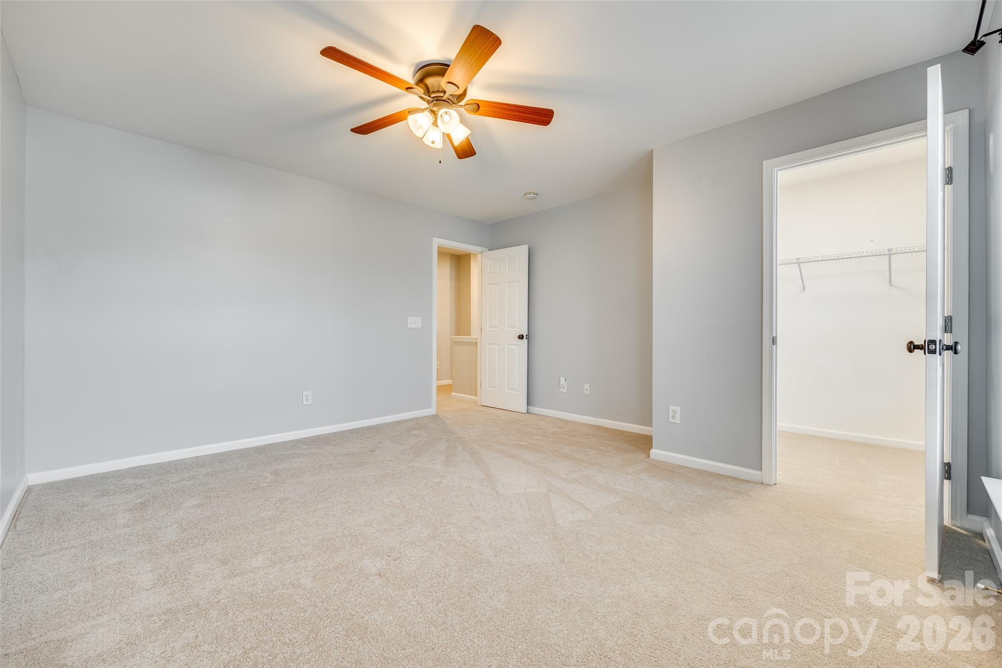618 Bayou Circle Clover, SC 29710 - Photo 21 of 31 an empty room with a chandelier fan and windows