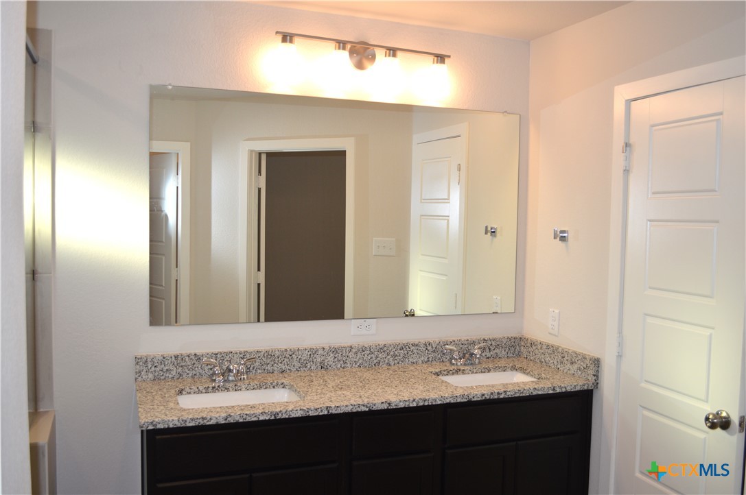 1911 Meridian Loop Temple, TX 76504 - Photo 12 of 26 a bathroom with a sink and a mirror