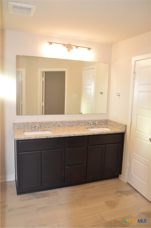 1911 Meridian Loop Temple, TX 76504 - Photo 13 of 26 a bathroom with a granite countertop double vanity sink and mirror