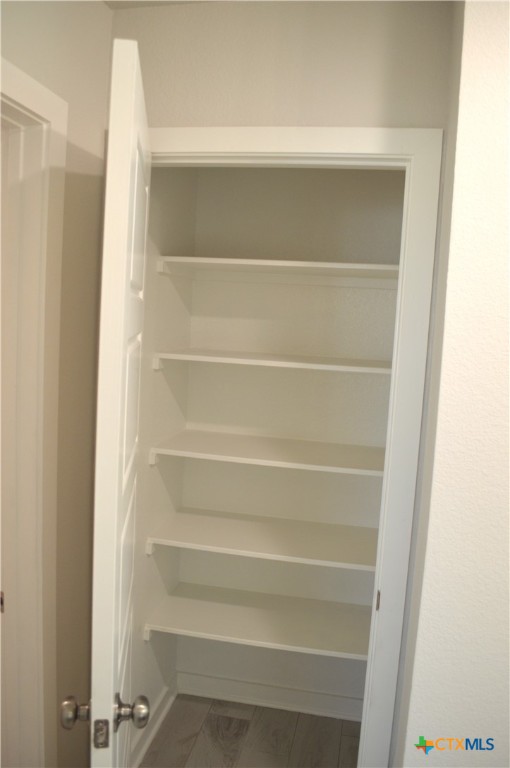 1911 Meridian Loop Temple, TX 76504 - Photo 5 of 26 a view of walk in closet with empty racks
