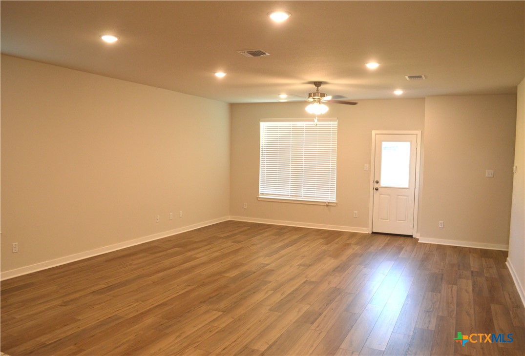 1911 Meridian Loop Temple, TX 76504 - Photo 7 of 26 an empty room with wooden floor and windows
