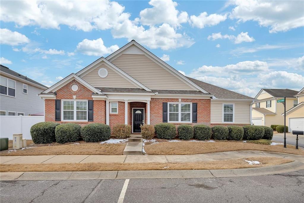 a front view of a house with a garden