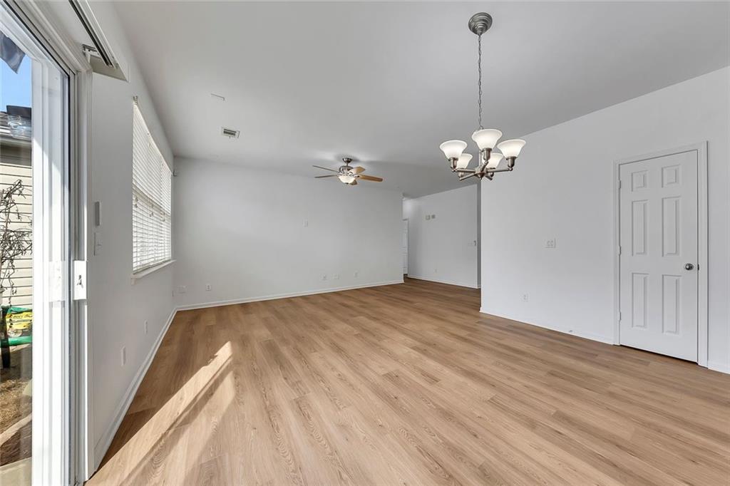3972 Cutler Donahoe Way Cumming, GA 30040 - Photo 16 of 46 a view of a room with wooden floor and chandelier