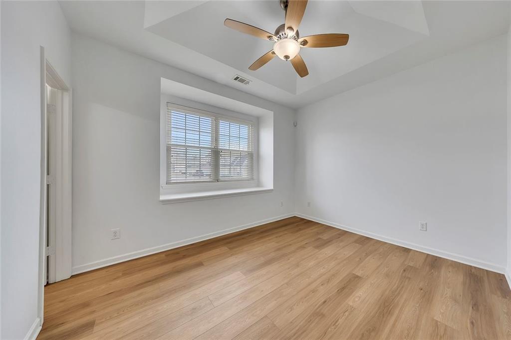 3972 Cutler Donahoe Way Cumming, GA 30040 - Photo 17 of 46 wooden floor in an empty room with a window