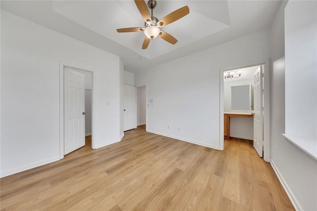 3972 Cutler Donahoe Way Cumming, GA 30040 - Photo 19 of 46 wooden floor in an empty room with a window