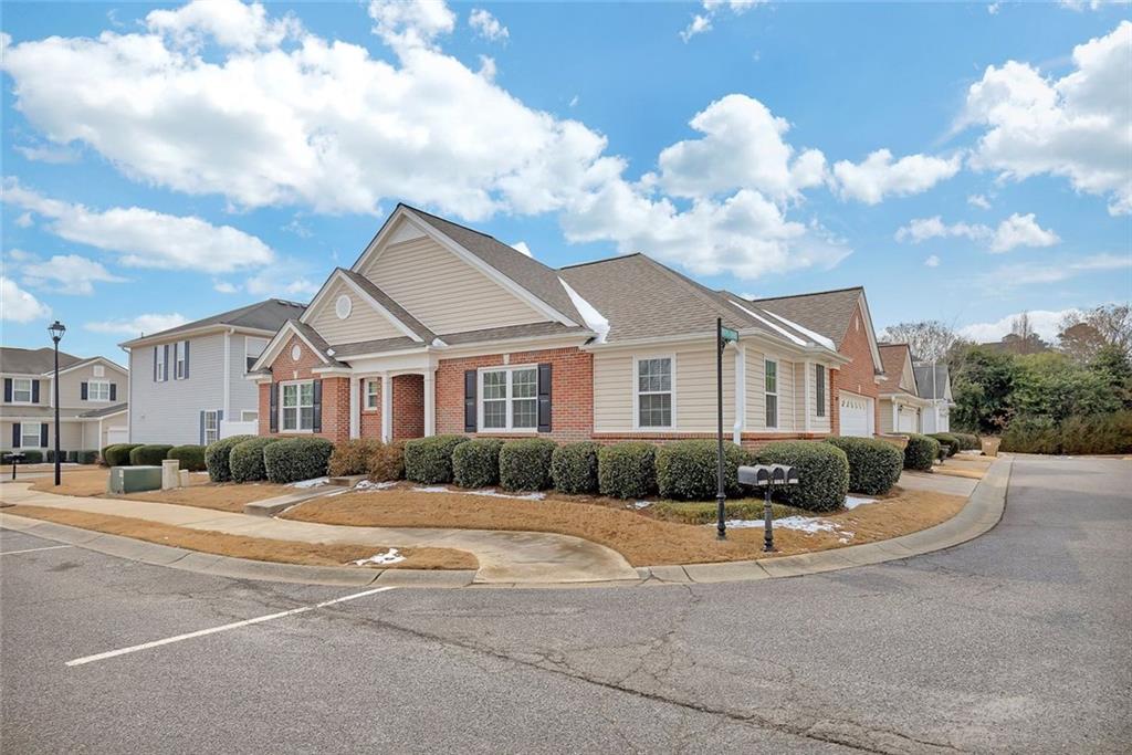 3972 Cutler Donahoe Way Cumming, GA 30040 - Photo 3 of 46 a view of a white house with a yard and plants