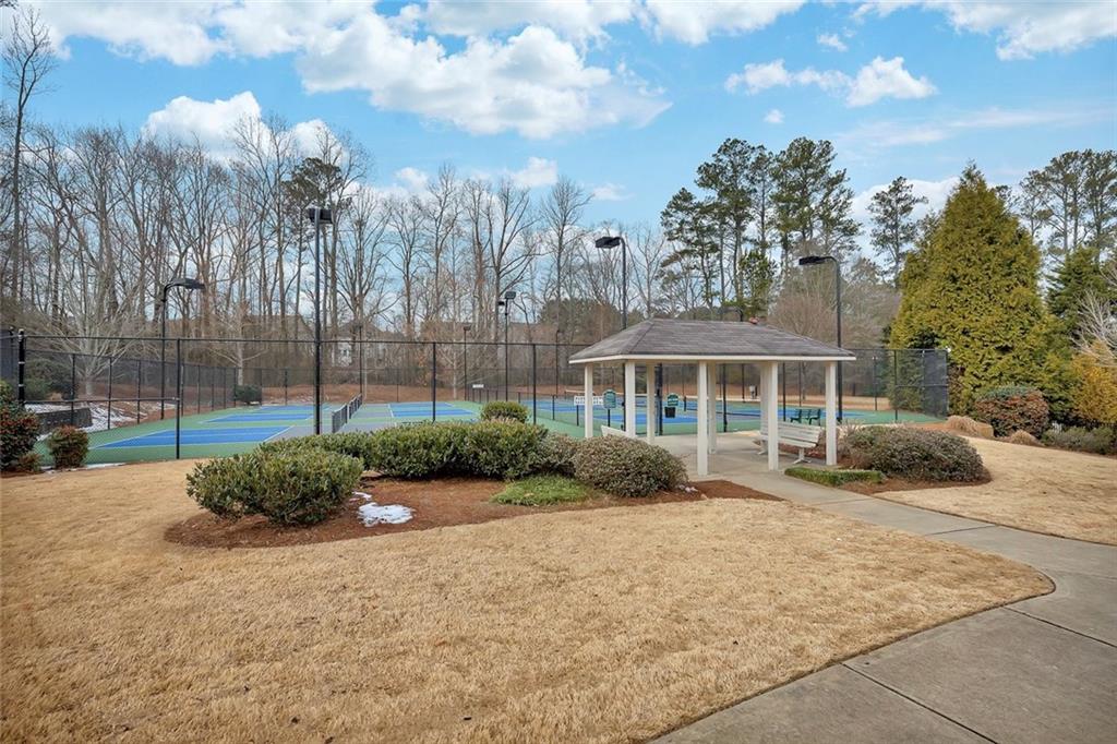 3972 Cutler Donahoe Way Cumming, GA 30040 - Photo 37 of 46 a front view of a house with a garden