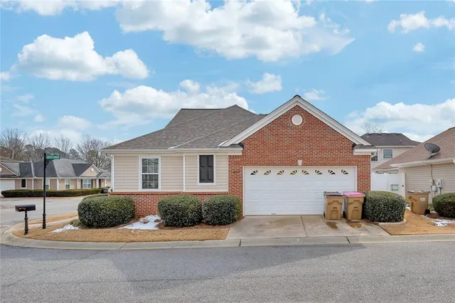 a view of a house next to a yard