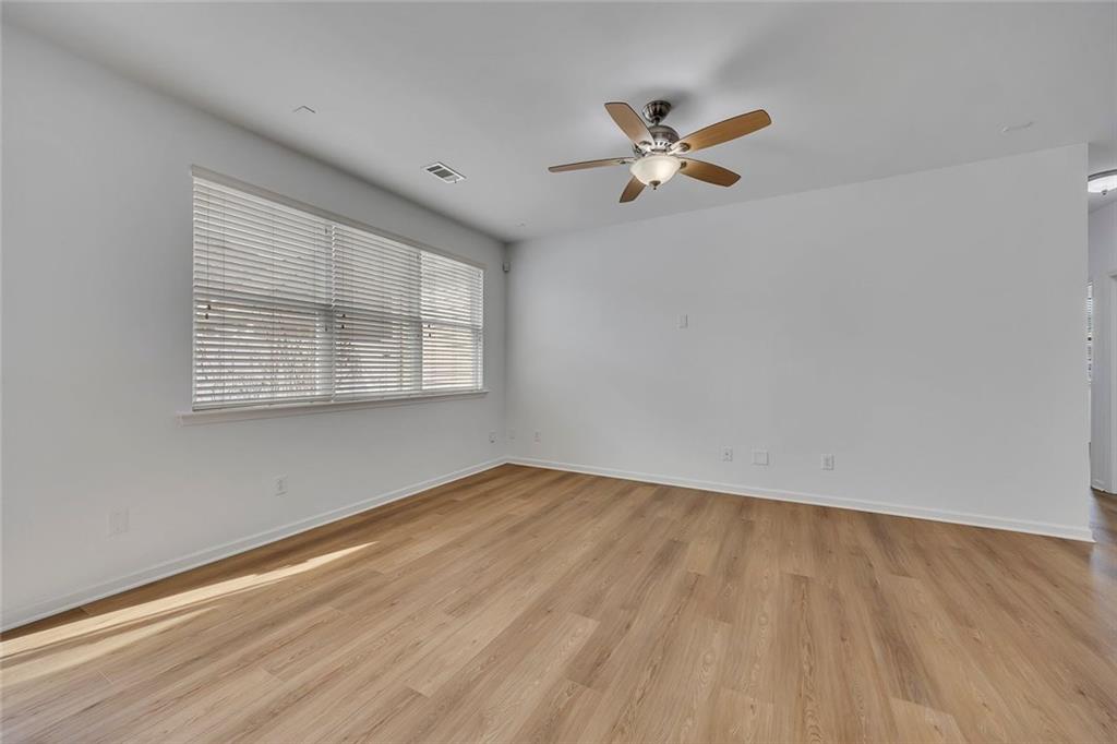 3972 Cutler Donahoe Way Cumming, GA 30040 - Photo 9 of 46 a view of empty room with wooden floor and fan