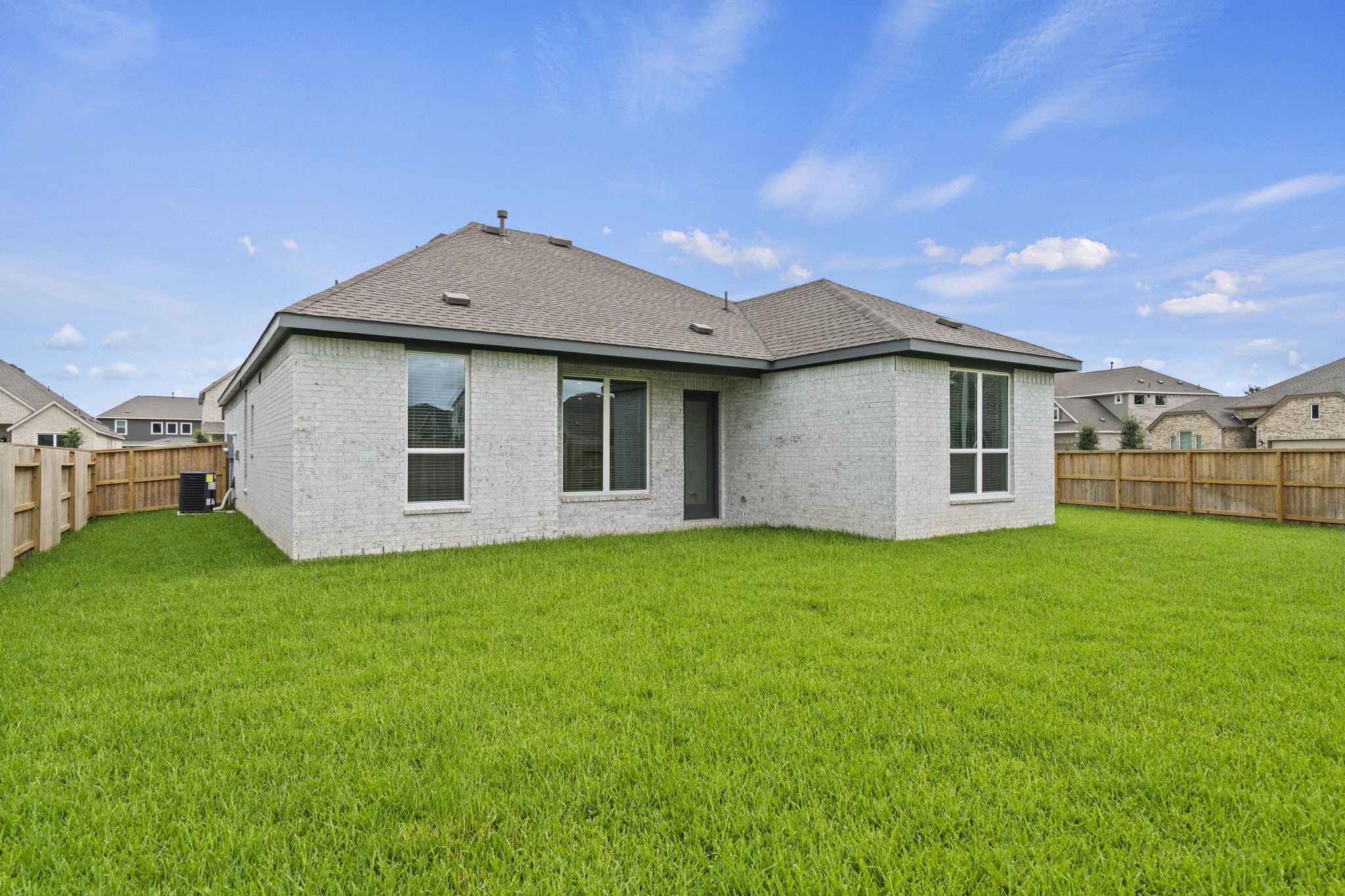 2720 Grove Crest Drive Rosenberg, TX 77469 - Photo 29 of 32 Expansive fenced backyard with a covered patio, offering plenty of space for outdoor entertaining, play, or future landscaping enhancements.