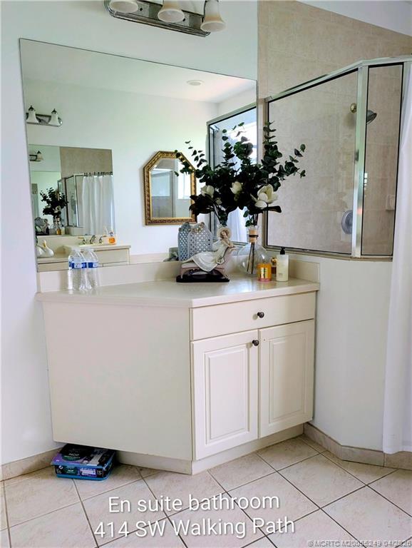 414 Southwest Walking Path, Unit 414 Stuart, FL 34997 - Photo 8 of 15 a bathroom with a sink and mirror