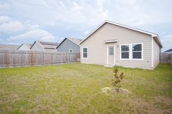 a view of a house with a backyard