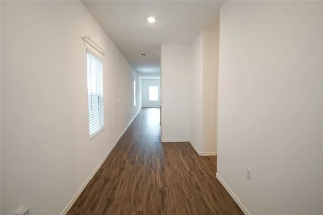 a view of a room with wooden floor and window