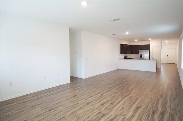 a view of a kitchen with a sink and wooden floor