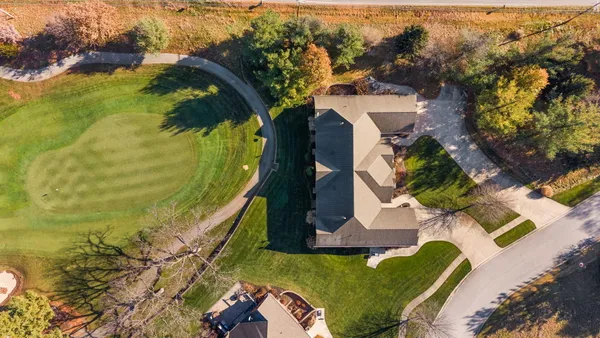 an aerial view of residential houses with outdoor space