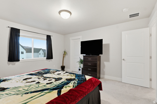 2011 Wren Circle Logan, UT 84339 - Photo 11 of 20 Primary bedroom featuring light colored carpet and baseboards