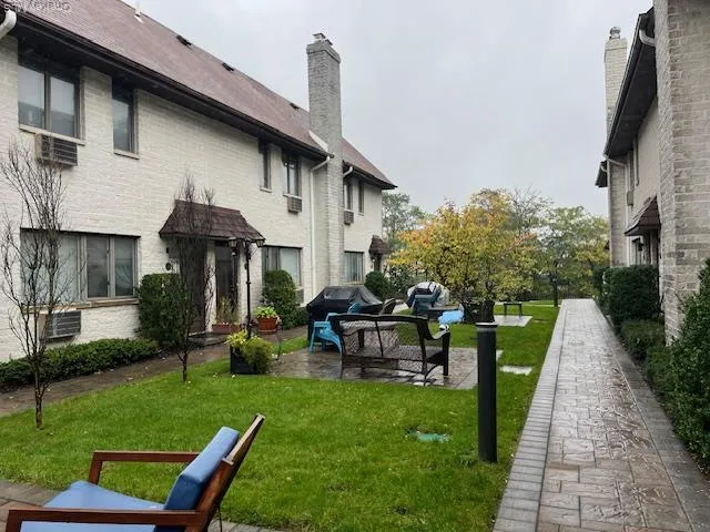 a view of a house with backyard sitting area and garden