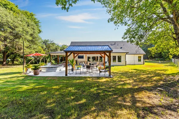 a view of a house with swimming pool and sitting area