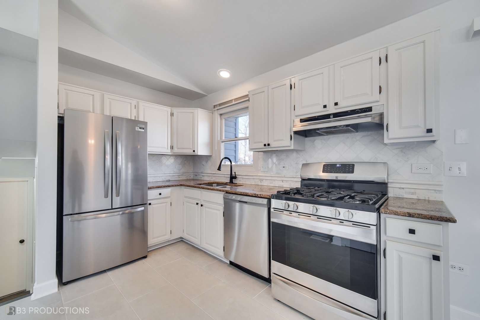 1722 Red Bud Road Bolingbrook, IL 60490 - Photo 7 of 29 a kitchen with white cabinets and stainless steel appliances