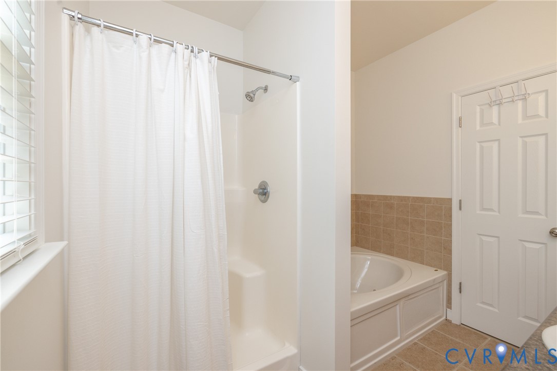 15618 Rowlett Road Chesterfield, VA 23838 - Photo 10 of 29 a bathroom with a shower curtain and a sink