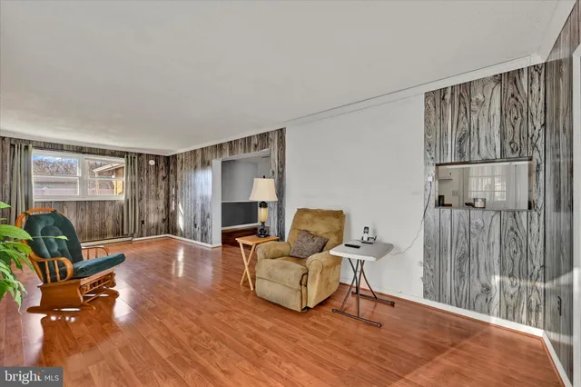 a living room with furniture flat screen tv and wooden floor